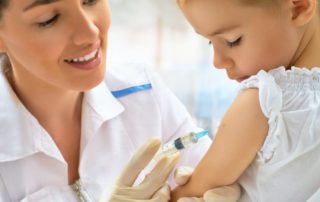 Doctor immunizing a child